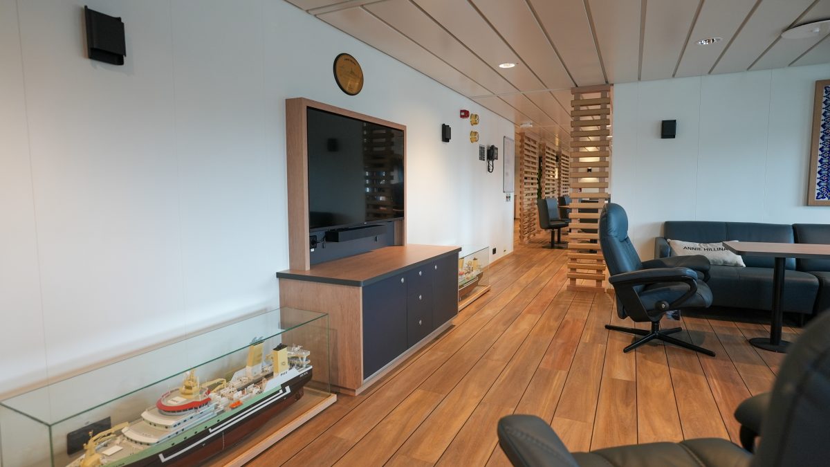 Accomar Marine TV Lounge With Ship Model Display And Modern Seating